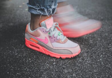 person wearing pink and white nike sneakers