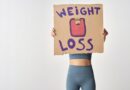 Person Holding a Cardboard with Weight Loss Message
