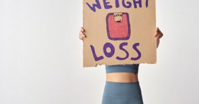 Person Holding a Cardboard with Weight Loss Message